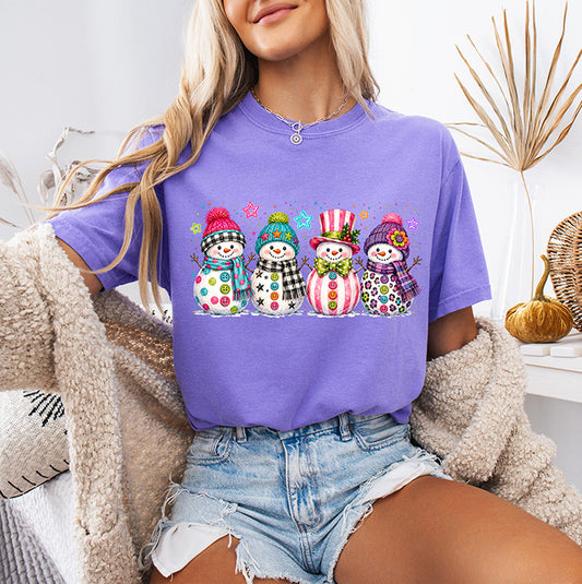 Colorful preppy Christmas DTF transfer featuring four festive snowmen in bright patterned winter hats and accessories