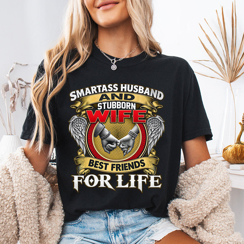 Smartass Husband and Stubborn Wife Best Friends for Life DTF transfer with gold banners, red lettering, angel wings, and pinky promise design on a black T-shirt.