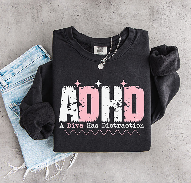 ADHD A Diva Has Distraction DTF transfer with distressed pink and white typography on a black sweatshirt