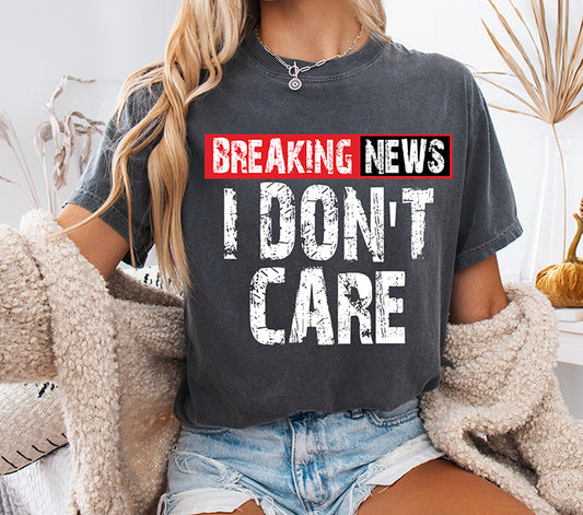 Breaking News I Don't Care DTF transfer with bold distressed white lettering and red breaking news banner