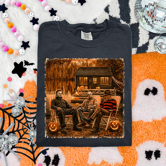 Vintage cabin horror Halloween DTF transfer featuring three slasher inspired characters, glowing pumpkins and rustic cabin scene