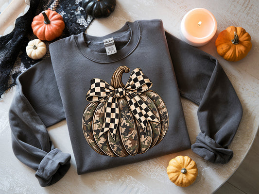 Camo pumpkin DTF transfer featuring an earthy camouflage pumpkin with an oversized black and cream checkerboard bow