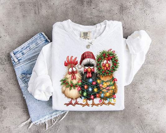 Funny Christmas chickens DTF transfer with three festive hens wrapped in colorful lights greenery berries and holiday decorations