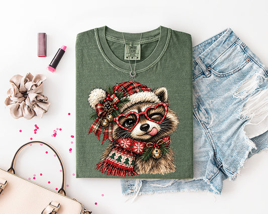 Cute Christmas raccoon DTF transfer featuring a raccoon in red heart glasses, plaid Santa hat, festive scarf, greenery, berries and Christmas bells