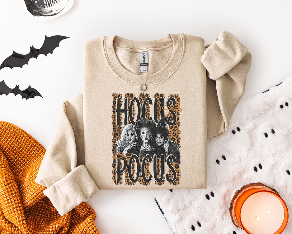 Hocus Pocus Halloween DTF transfer featuring three vintage spooky witches with bold Hocus Pocus lettering, orange bows and leopard print background