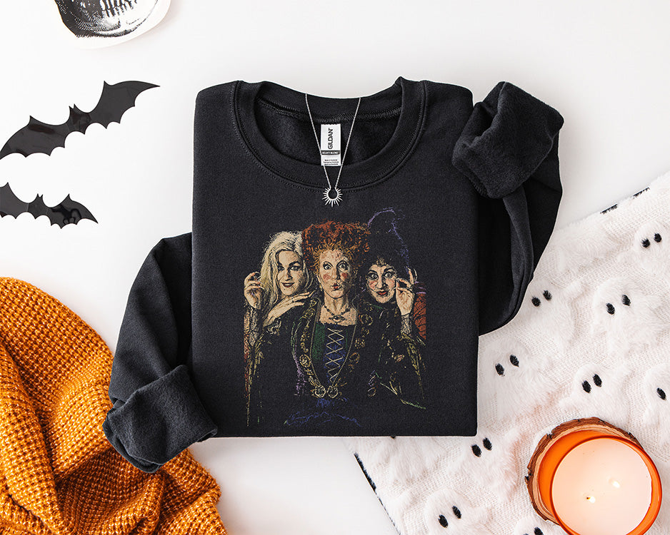 Vintage Halloween witch sisters DTF transfer featuring three spooky witches in distressed retro artwork on a black sweatshirt