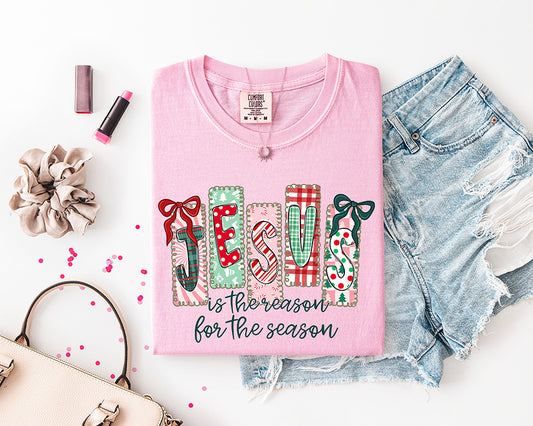 Jesus Is the Reason for the Season Christian Christmas DTF transfer with colorful patchwork JESUS lettering, plaid patterns, candy cane stripes, bows, and festive holiday details.