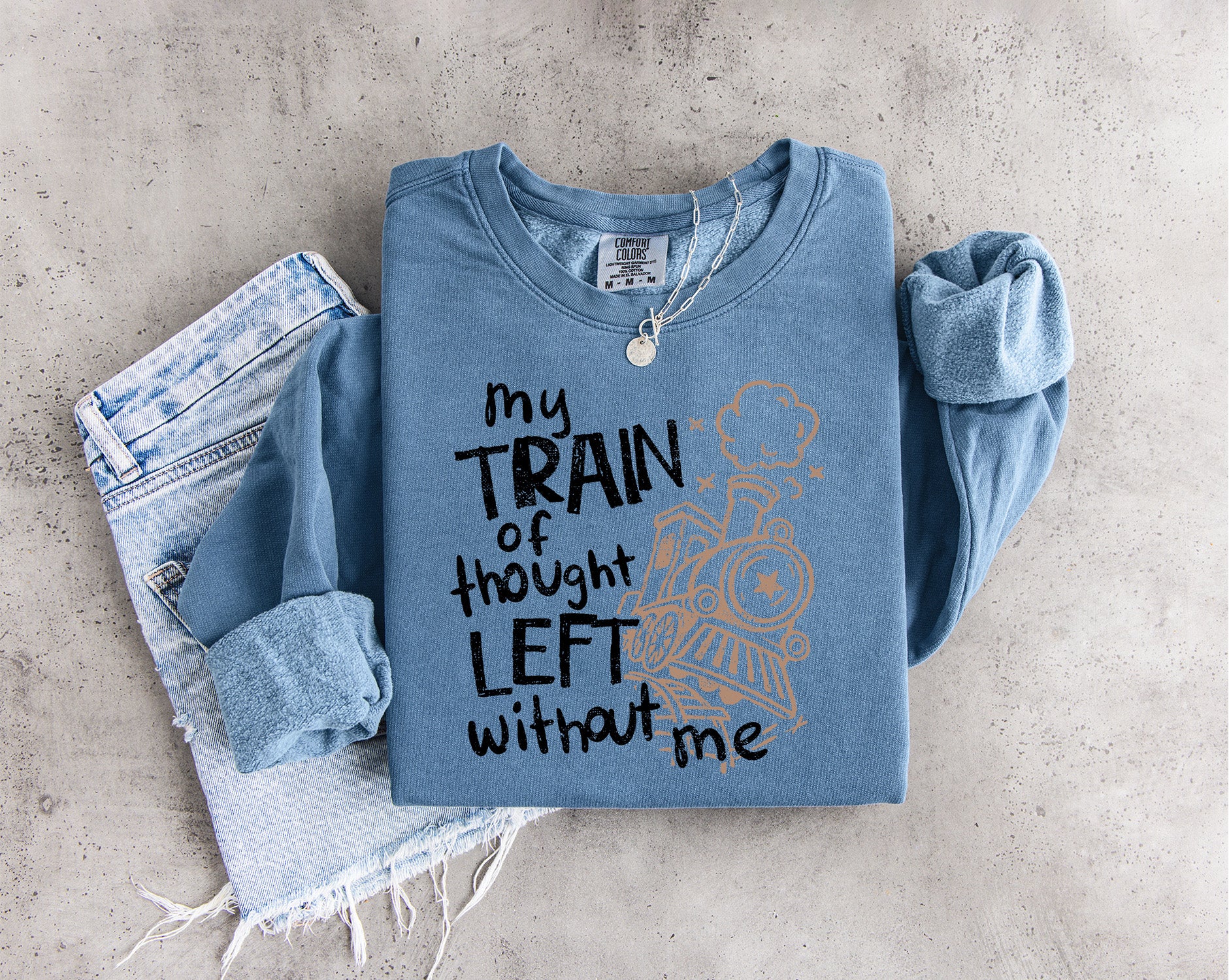 My Train of Thought Left Without Me DTF transfer featuring distressed black lettering and a whimsical vintage train illustration.