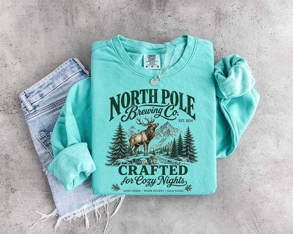 North Pole Brewing Co vintage Christmas DTF transfer with elk mountains evergreen trees and Crafted for Cozy Nights lettering