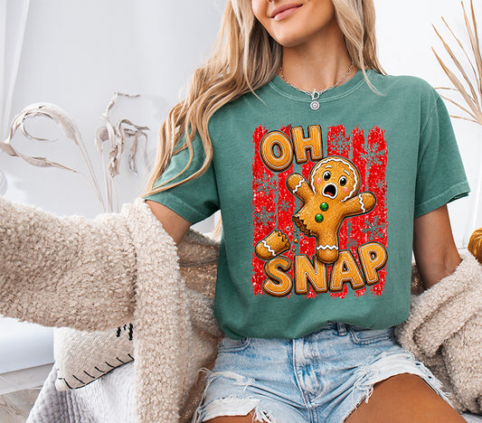 Oh Snap Christmas DTF transfer featuring a funny broken gingerbread man with bold retro lettering, snowflakes and distressed red background