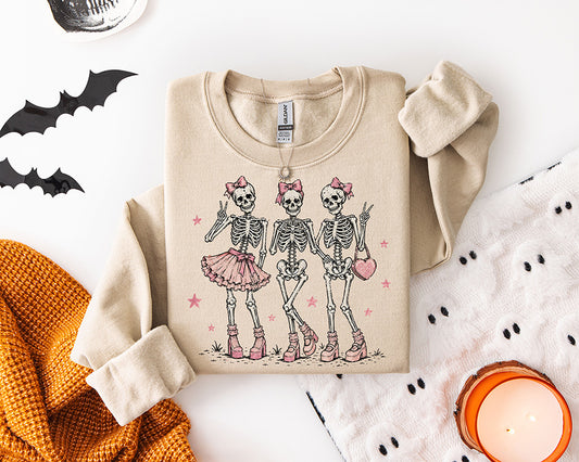 Girly Halloween DTF transfer featuring three skeleton Besties wearing pink bows platform heels a tutu and heart purse