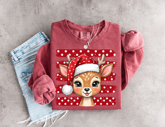 Cute Christmas reindeer DTF transfer featuring an adorable reindeer wearing a red polka dot Santa hat with festive red and white background