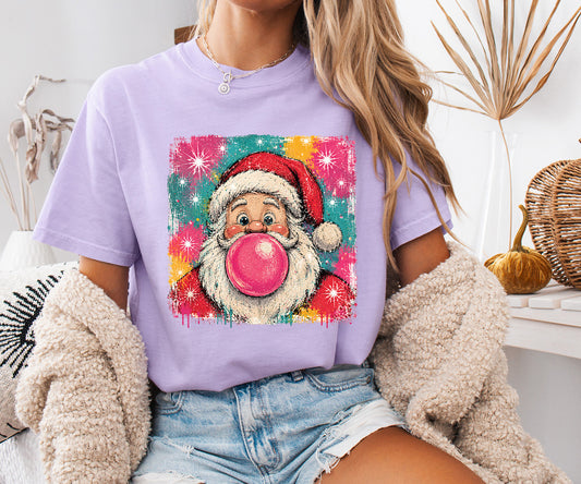 Pink Bubblegum Santa DTF transfer featuring retro Santa blowing a hot pink bubble with colorful turquoise pink and red Christmas background