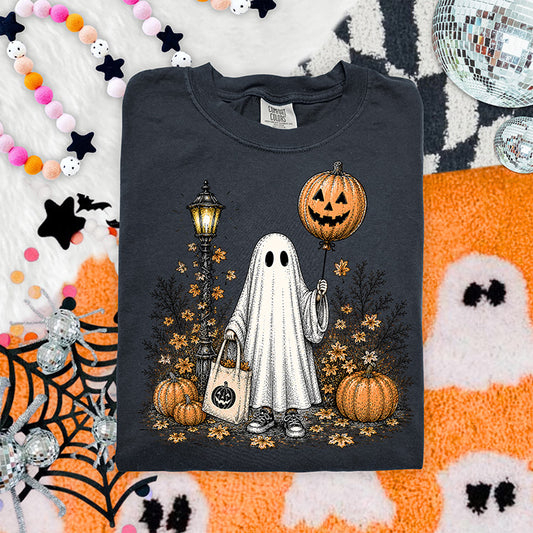 Trick or treat ghost Halloween DTF transfer featuring sheet ghost with pumpkin balloon candy bag pumpkins autumn leaves and vintage streetlamp
