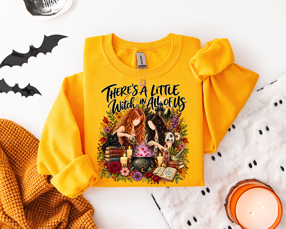 There's a Little Witch in All of Us DTF transfer featuring two witchy best friends with a bubbling cauldron, black cat, spell books, candles and fall flowers