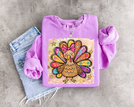 Colorful watercolor Thanksgiving turkey DTF transfer with pink bow and bright patterned feathers